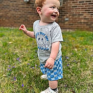Dawson joined the competition — help win amazing prizes! toddler, child, grass, outdoor, smiling, happy, red_hair, shorts, tshirt, shoes, sneakers, nature, flower, greenery, portrait, person, cute, playful, young_child, daylight