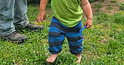 Dane joined the competition — help win amazing prizes! toddler, child, barefoot, grass, blue_sunglasses, green_tank_top, striped_pants, outdoor, person, adult, jeans, boots, dirt, toy, summer, nature, cute, portrait, fun, playful