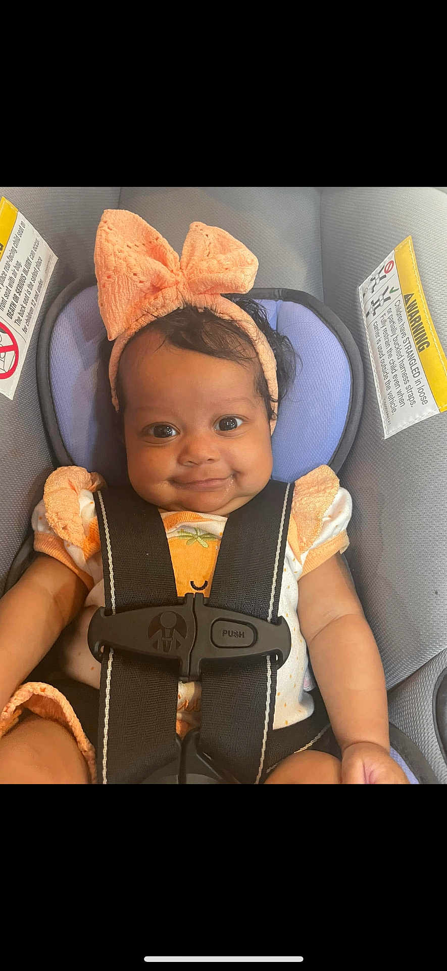 Dayalani is registered to the contest to win money with this photo: baby, child, car_seat, seatbelt, bow, headband, smile, cute, infant, clothing, sitting, child_safety, portrait, happy, young, person, closeup, indoor, car, seat
