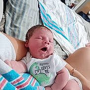 Ryker joined the competition — help win amazing prizes! newborn, baby, sleeping, infant, onesie, dinosaur, text_on_clothing, bed, blanket, striped, arm, person, indoors, cozy, closeup, cute, peaceful, skin, human, resting