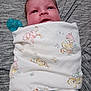 Ryker is registered to the contest to win money with this photo: baby, infant, swaddled, blanket, pacifier, cute, face, newborn, child, lying_down, soft_texture, patterned_blanket, comfort, wrapped, blue, gray, expression, human, portrait, cozy