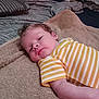 Ryker is registered to the contest to win money with this photo: baby, infant, child, striped_clothing, yellow, white, towel, bed, pillow, blanket, curly_hair, face, skin, relaxed, lying_down, indoor, cozy, soft_texture, person, portrait