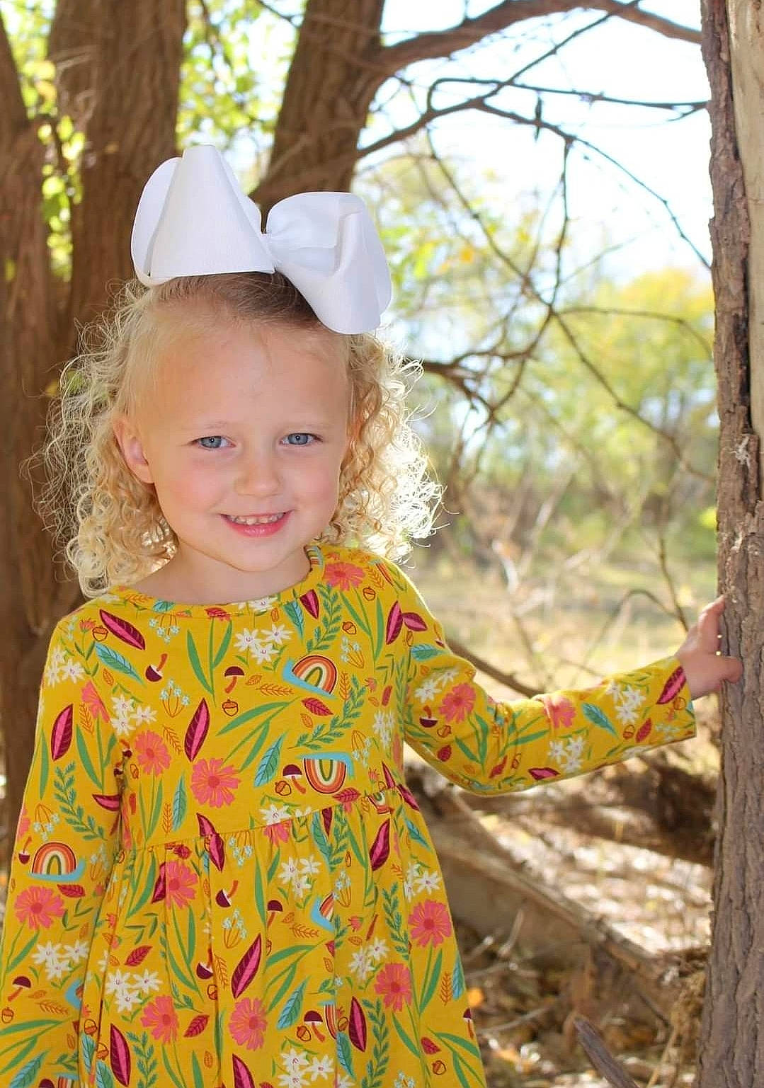 Tynsleigh joined the competition — help win amazing prizes! baby_toddler_clothing, blond, branch, eye, face, fun, grass, happy, head, joy, leaf, pattern, people_in_nature, person, skin, sleeve, smile, toddler, tree, twig