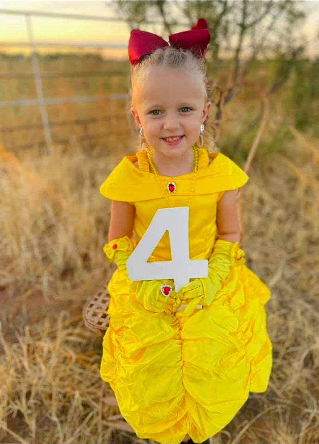 Tynsleigh is registered to the contest to win money with this photo: baby_toddler_clothing, blond, child, dress, eye, face, fun, grass, happy, head, joy, outerwear, pattern, people_in_nature, person, personal_protective_equipment, plant, pumpkin, sleeve, smile