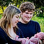 baby, child, couple, family, grass, happy, holding, infant, love, man, nature, newborn, outdoor, parent, people, portrait, smile, tender, trees, woman