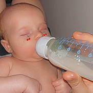 Emersyn is registered to the contest to win money with this photo: baby, bottle, cherry_stickers, child, closeup, cute, feeding, feeding_bottle, hand, human, indoor, infant, milk, newborn, peaceful, portrait, resting, skin, sleeping, towel