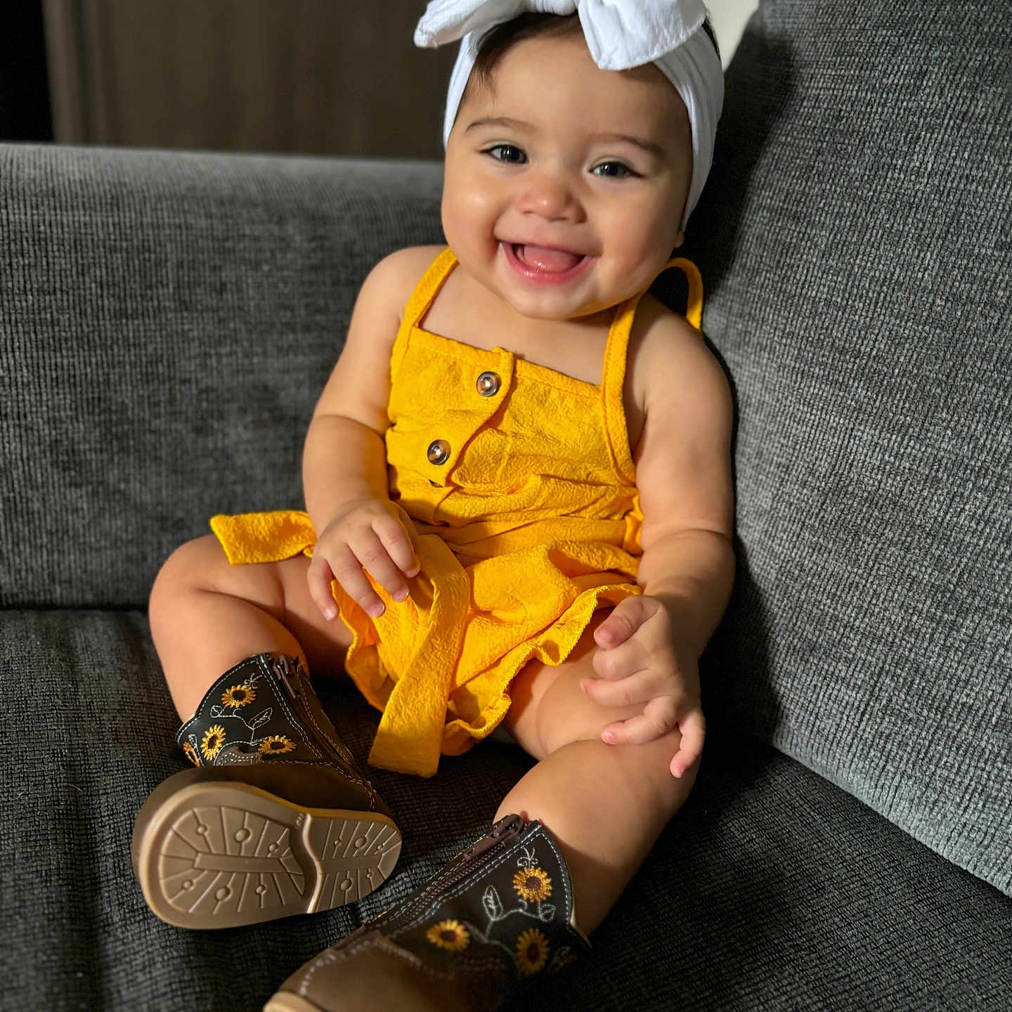 Avigail Khouri joined the competition — help win amazing prizes! baby, bodypart, cap, clothing, couch, face, finger, footwear, furniture, hand, happy, hat, head, person, photography, portrait, shoe, sitting, smile, sneaker