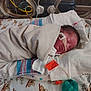 Connor is registered to the contest to win money with this photo: newborn, baby, hospital, incubator, medical_equipment, blanket, striped_blanket, face_tape, sleeping, pacifier, tube, crib, infant, swaddled, healthcare, tiny, cute, resting, bed, toddler