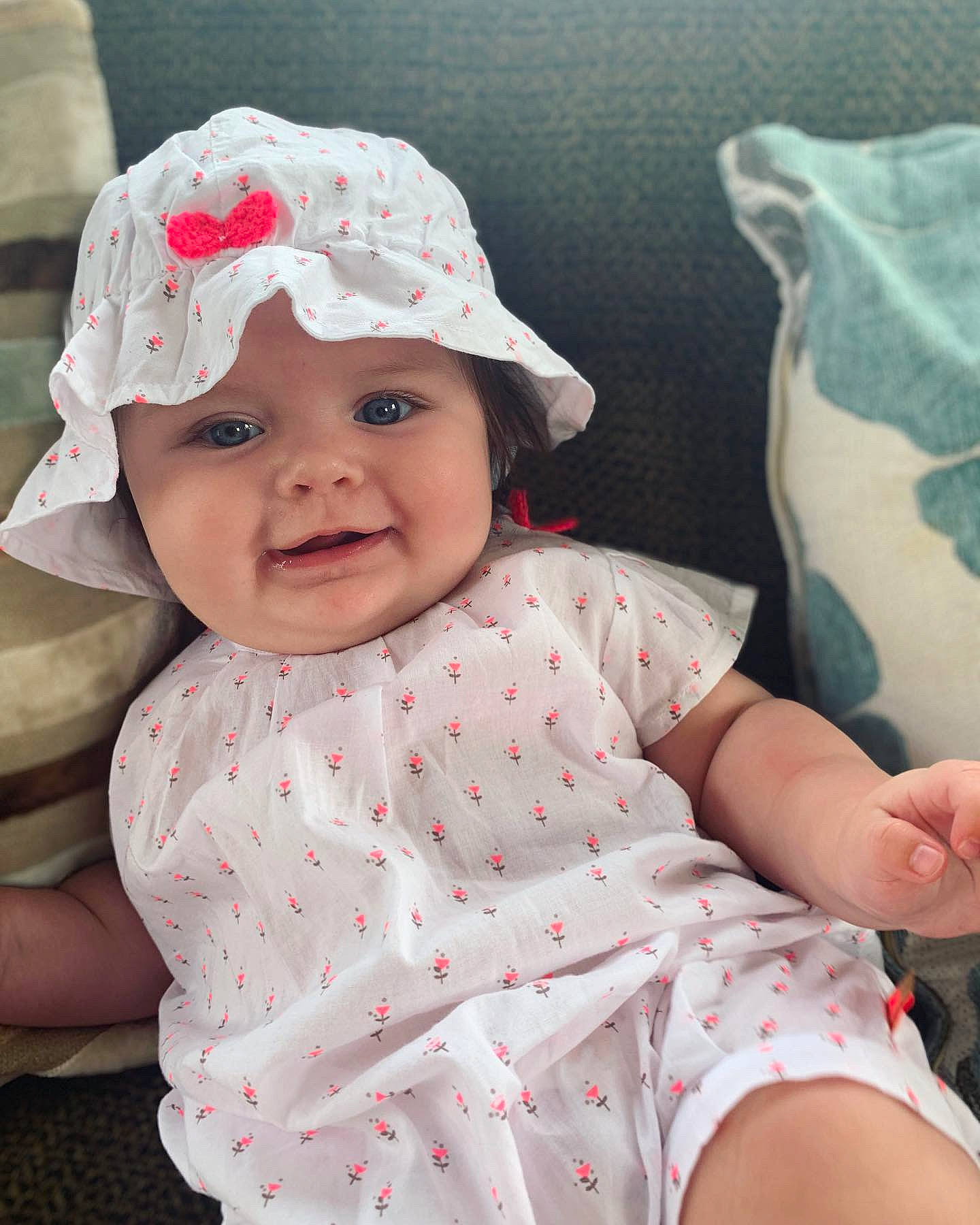 Harlie joined the competition — help win amazing prizes! baby, baby_toddler_clothing, bonnet, cap, cheek, child, dress, hat, headgear, headwear, pattern, person, pink, skin, sleeve, smile, sun_hat, toddler
