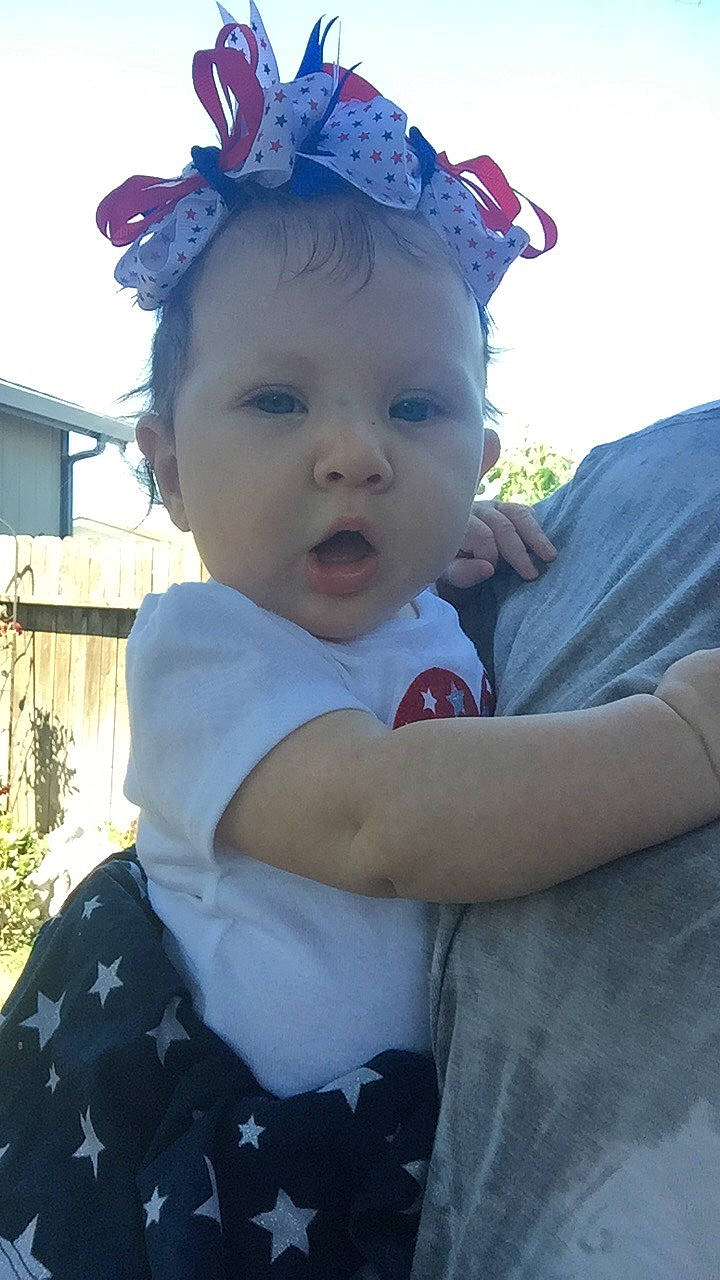 Christina is registered to the contest to win money with this photo: baby, cheek, child, ear, face, fashion_accessory, forehead, fun, hair_accessory, head, headband, headgear, person, pink, plant, skin, smile, summer, surprise, toddler