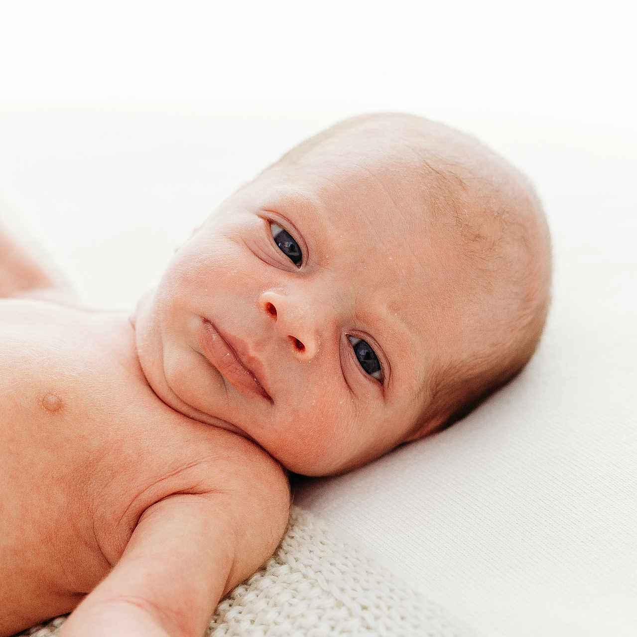Bude joined the competition — help win amazing prizes! baby, blanket, child, closeup, curious, cute, expression, eyes, face, head, human, infant, lying_down, newborn, newborn_baby, person, portrait, skin, soft, white