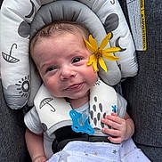 Brentley joined the competition — help win amazing prizes! baby, baby_seat, blanket, blue_eyes, brown_hair, child, close_up, clothing, cushion, face, flower, hand, happy, indoor, infant, pacifier, portrait, sitting, smiling, textile
