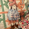 baby, infant, quilt, plaid_shorts, suspenders, brown_shoes, white_socks, clothing, hand, adult_hand, bracelets, floral_shirt, pacifier, bedroom, fabric, pattern, cute, lying_down, person, indoor