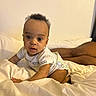 baby, infant, onesie, bed, bedding, drool, curious, wide_eyes, person, skin, legs, white, soft, indoors, crawling, child, young, cute, expression, resting