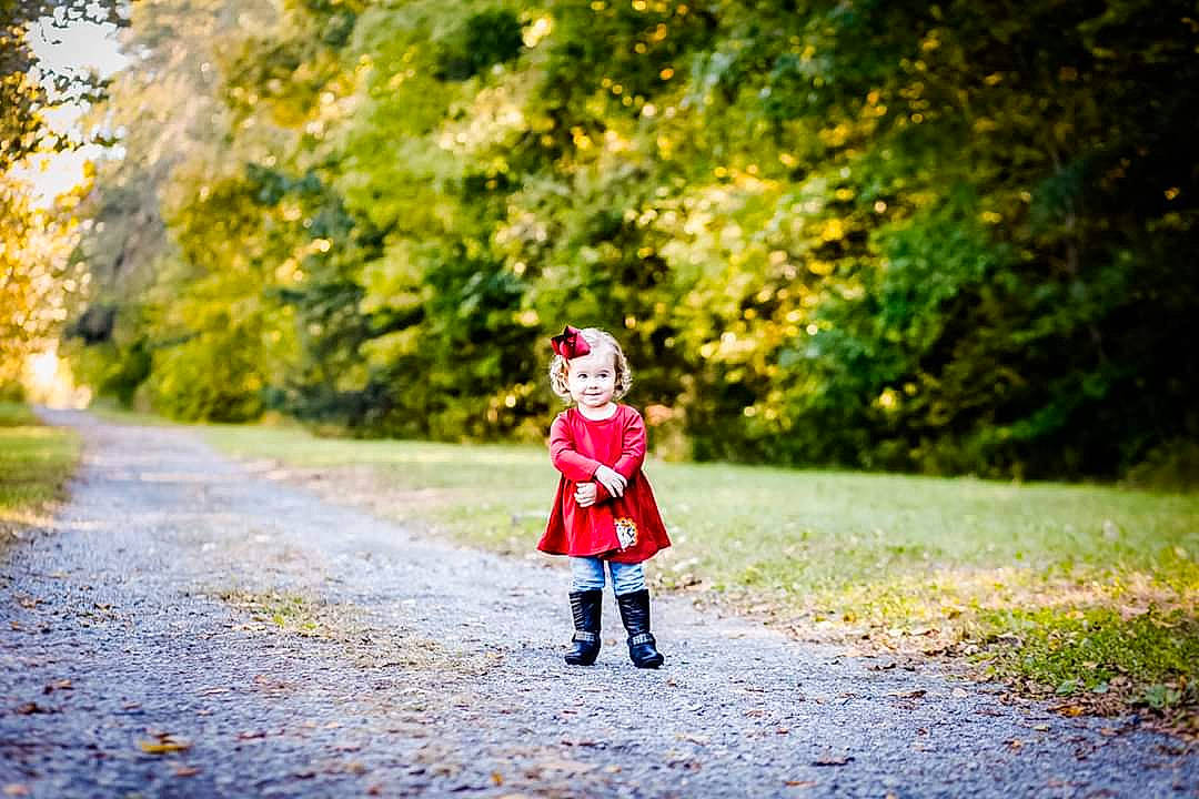 Kendalynn is registered to the contest to win money with this photo: autumn, child, dress, footwear, grass, leaf, leisure, nature, outerwear, pattern, people_in_nature, person, photograph, photography, plant, portrait_photography, red, road, toddler, tree