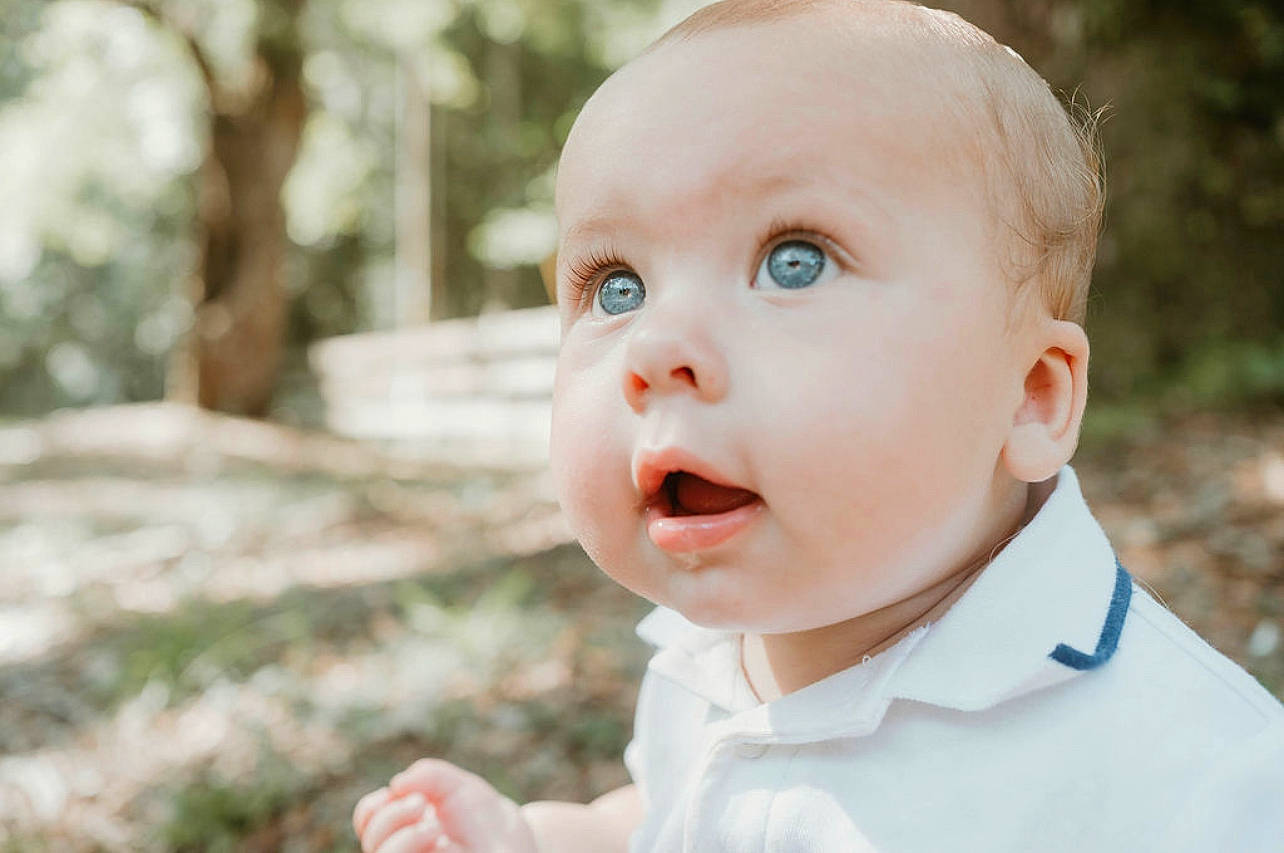 Logan is registered to the contest to win money with this photo: baby, baby_toddler_clothing, cheek, child, dress, eyelash, flash_photography, fun, gesture, grass, happy, iris, lip, nose, people_in_nature, person, plant, skin, smile, surprise