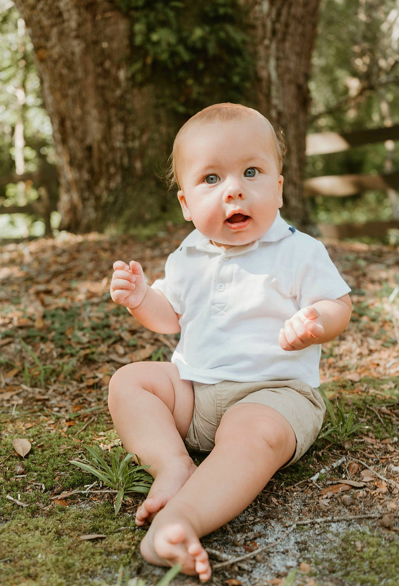 Logan joined the competition — help win amazing prizes! baby, baby_toddler_clothing, child, eye, flash_photography, foot, fun, grass, happy, human_leg, people_in_nature, person, plant, portrait_photography, sitting, skin, smile, sunlight, toddler, tree