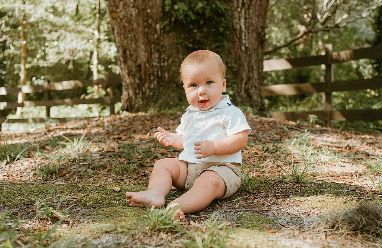 Logan joined the competition — help win amazing prizes! baby, baby_toddler_clothing, child, eye, flash_photography, forest, fun, grass, happy, leaf, leisure, people_in_nature, person, plant, smile, sunlight, toddler, tree, trunk, wood