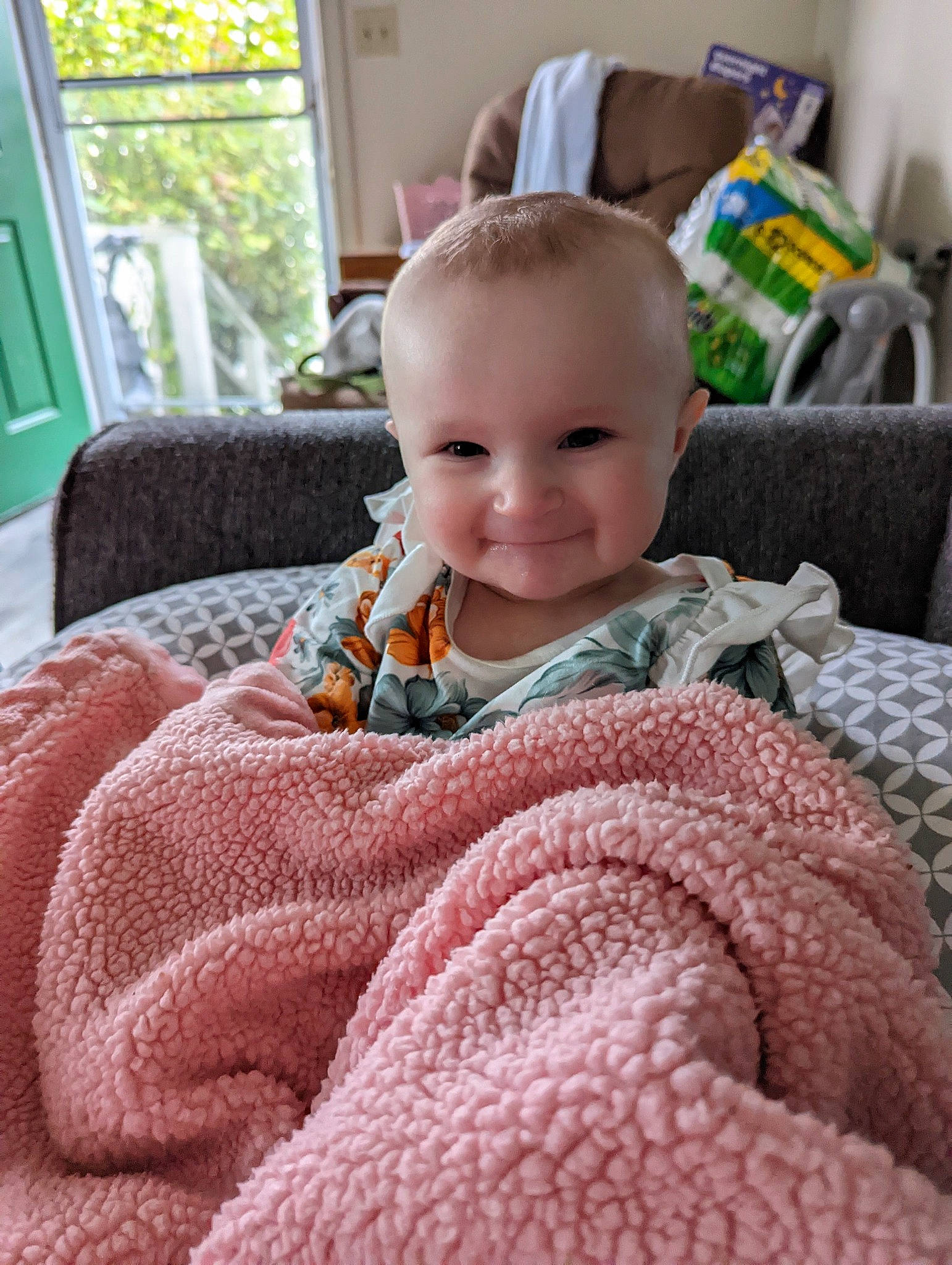 Jennie joined the competition — help win amazing prizes! baby, baby_toddler_clothing, cheek, child, comfort, couch, facial_expression, flooring, iris, joy, linens, nose, pattern, person, product, room, sitting, skin, sleeve, smile