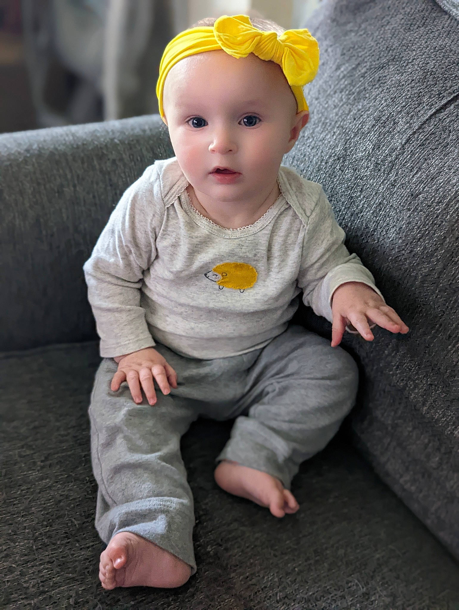 Jennie joined the competition — help win amazing prizes! baby, baby_toddler_clothing, cap, cheek, child, chin, comfort, eye, face, foot, grey, head, headband, headwear, iris, lip, person, sitting, skin, sleeve