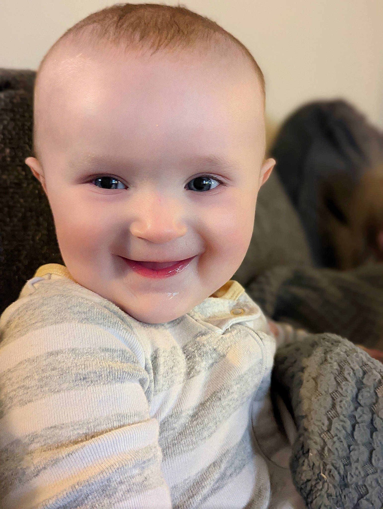 Jennie is registered to the contest to win money with this photo: baby, baby_toddler_clothing, blond, cheek, chin, close_up, comfort, eye, eyebrow, flash_photography, hairstyle, happy, iris, joy, lip, nose, person, sitting, skin, sleeve