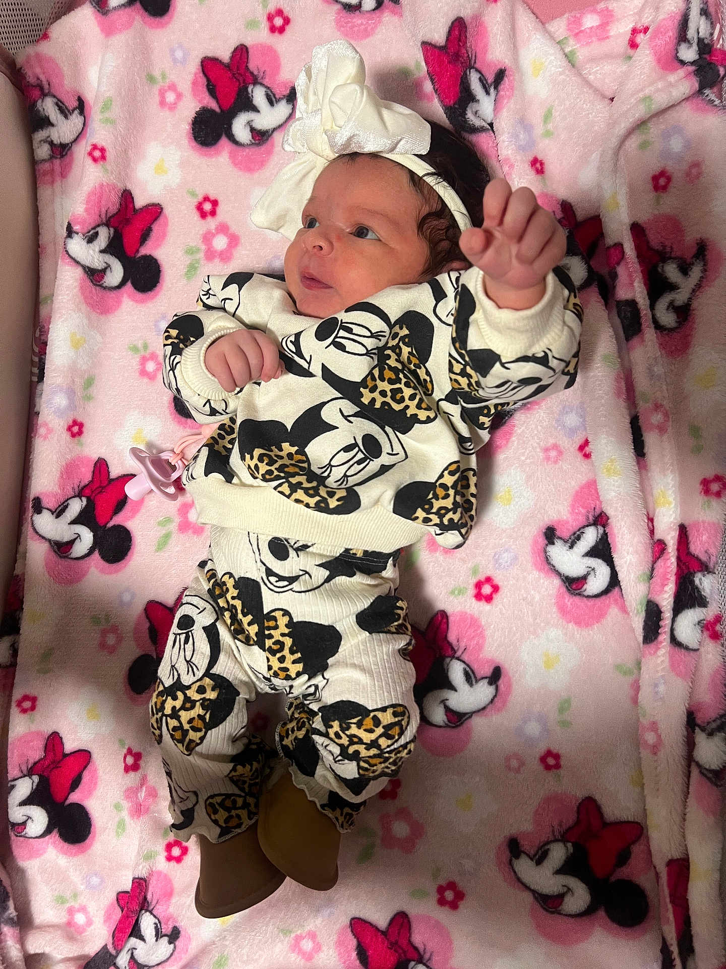 Elliana is registered to the contest to win money with this photo: baby, newborn, infant, headband, bow, minnie_mouse, blanket, pink, pattern, pacifier, outfit, gaze, hand, arm, legs, booties, crib, soft_fabric, cute, portrait