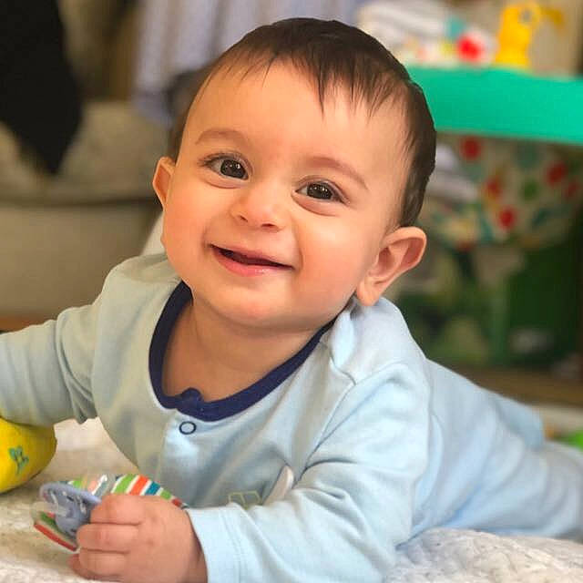 Harris is registered to the contest to win money with this photo: baby, baby_playing_with_toys, cheek, child, eye, facial_expression, finger, happy, joy, person, play, skin, smile, toddler, toy, tummy_time