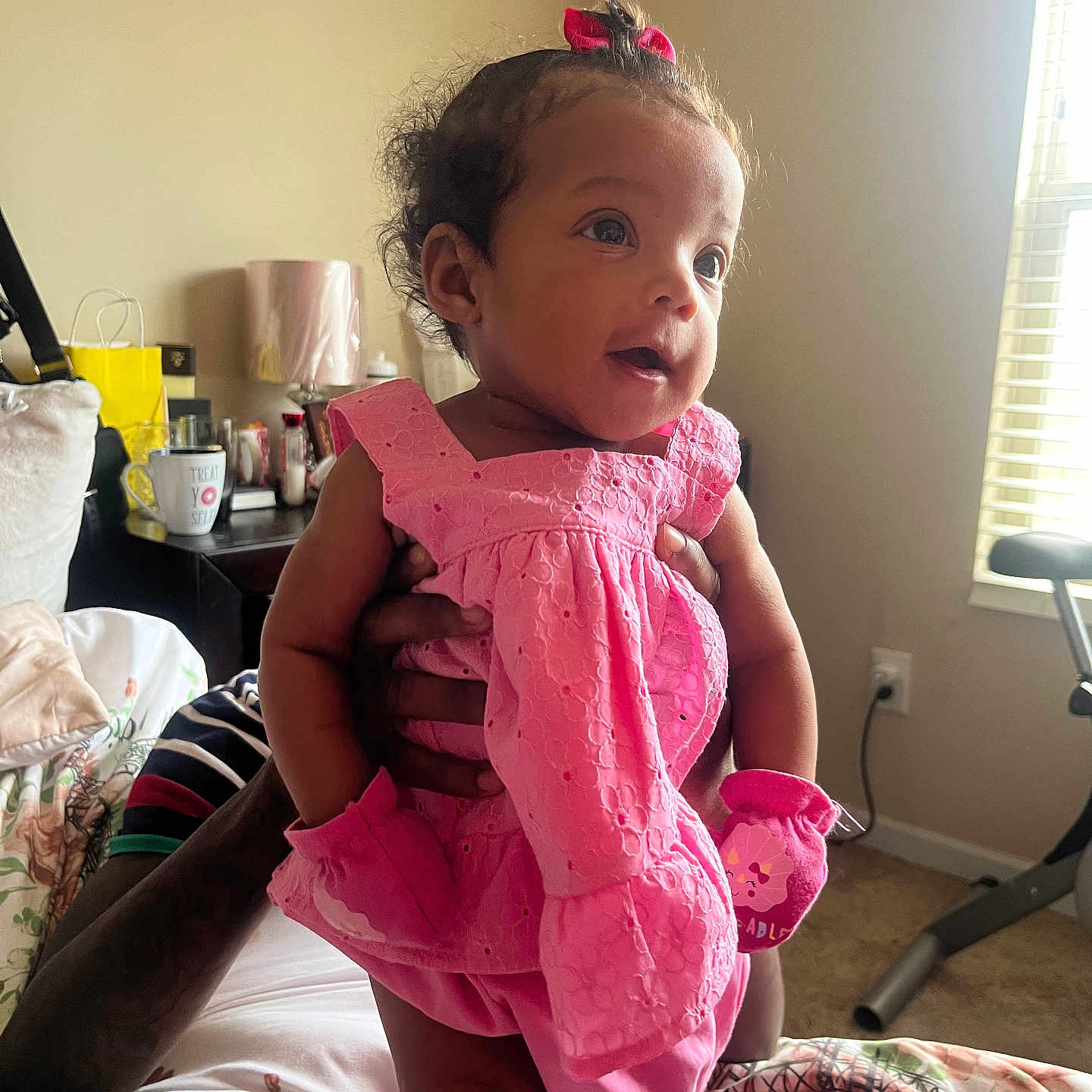 Sedora joined the competition — help win amazing prizes! adult_hands, baby, bed, bedroom, carpet, child, cup, decor, dress, indoor, lamp, mittens, natural_light, person, pillow, pink_clothing, portrait, smiling, table, window