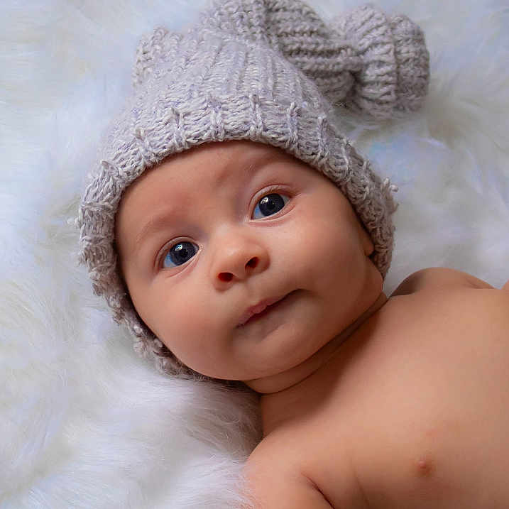 Kristopher is registered to the contest to win money with this photo: baby, bonnet, cap, cheek, child, eye, face, fashion_accessory, fur, head, headgear, headwear, knit_cap, lip, person, photography, portrait_photography, skin, toddler, wool