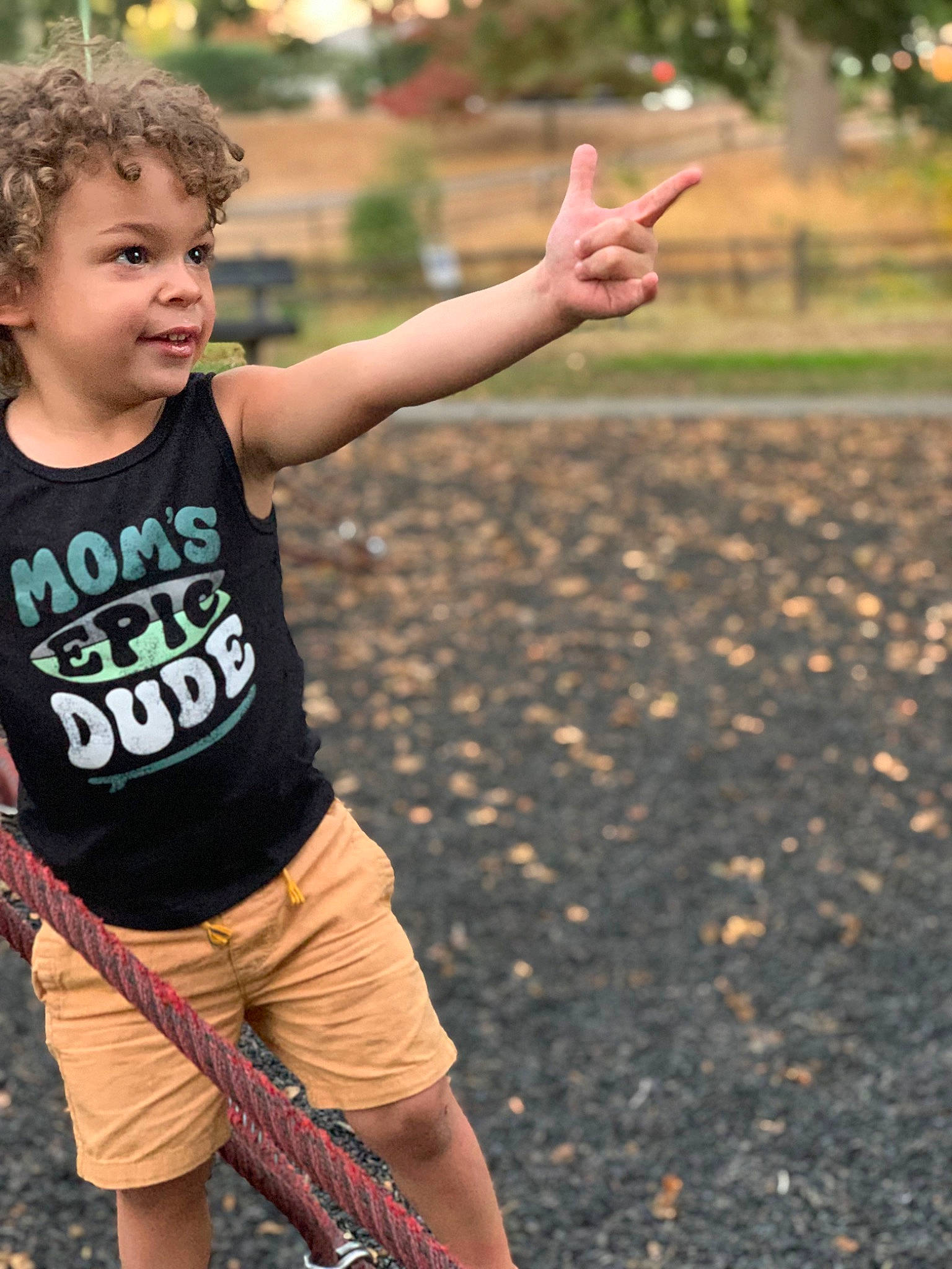 Liam is registered to the contest to win money with this photo: cool, finger, flash_photography, gesture, grass, hand, happy, joy, leisure, people_in_nature, person, plant, recreation, shorts, shoulder, smile, t_shirt, thigh, thumb, toddler