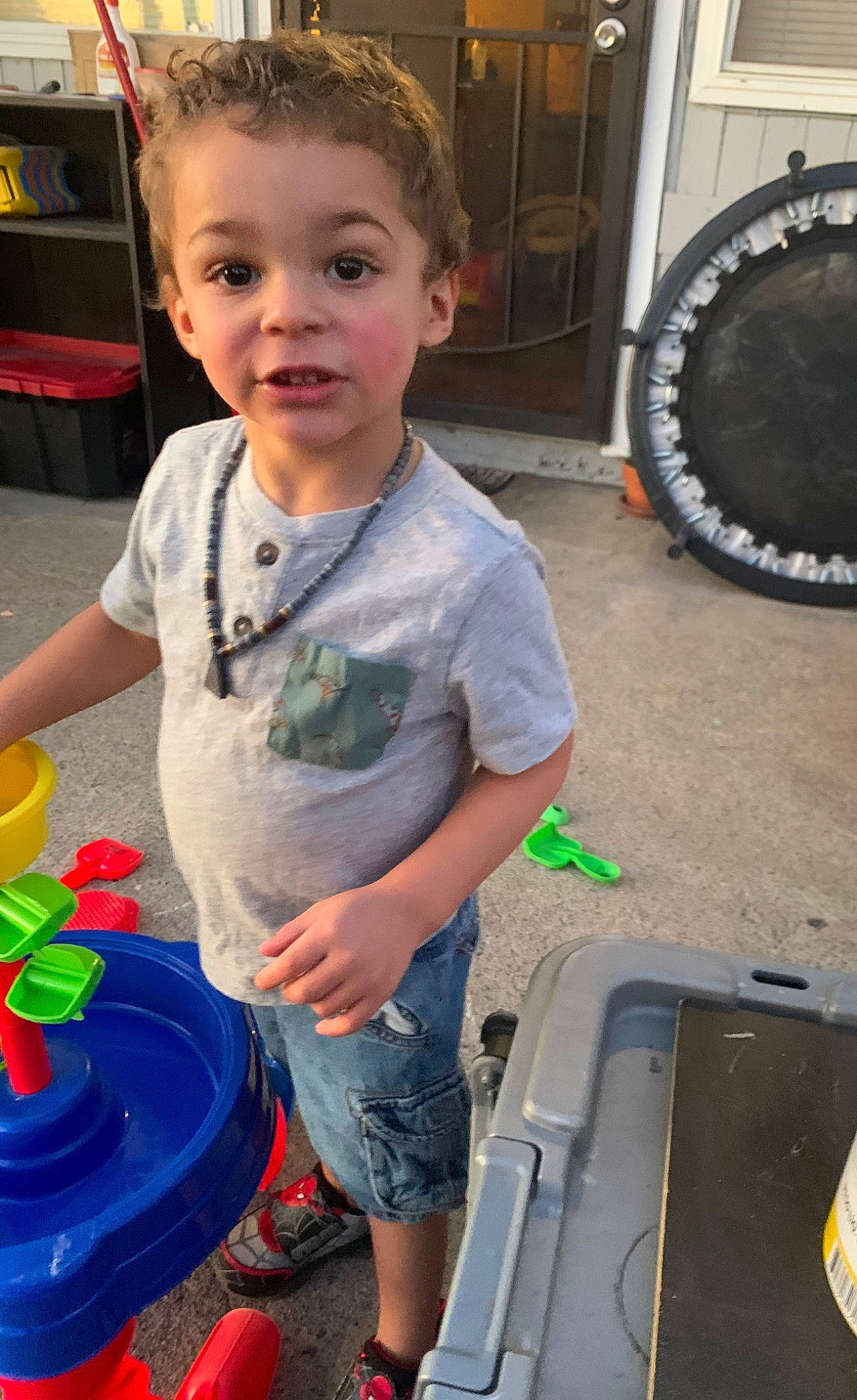 Liam is registered to the contest to win money with this photo: auto_part, automotive_tire, automotive_wheel_system, child, fun, hairstyle, leisure, person, play, product, public_space, shorts, sitting, smile, t_shirt, tire, toddler, vacation, wheel, wood