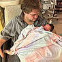 Roselynn joined the competition — help win amazing prizes! man, newborn, baby, hospital, blanket, chair, medical_equipment, indoor, person, tender, love, father, care, comfort, seated, portrait, human, hospital_room, newborn_baby, family