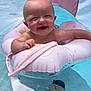baby, infant, smiling, pool, water, inflatable_ring, pink, floating, child, happy, summer, sunlight, canopy, sitting, barefoot, fun, outdoor, swimming, cute, joyful