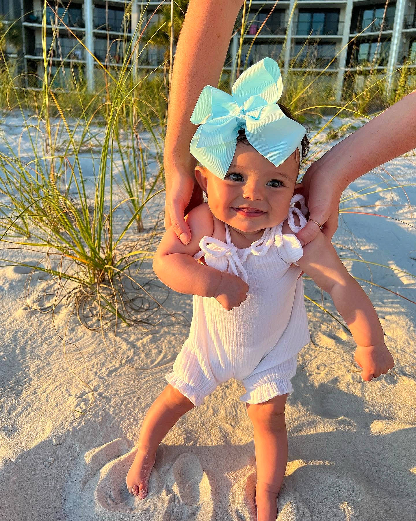 Blakely is registered to the contest to win money with this photo: barefoot, beach, child, eyewear, fashion_accessory, foot, fun, gesture, grass, happy, hat, headwear, human_leg, joy, leg, leisure, people_in_nature, people_on_beach, person, sand
