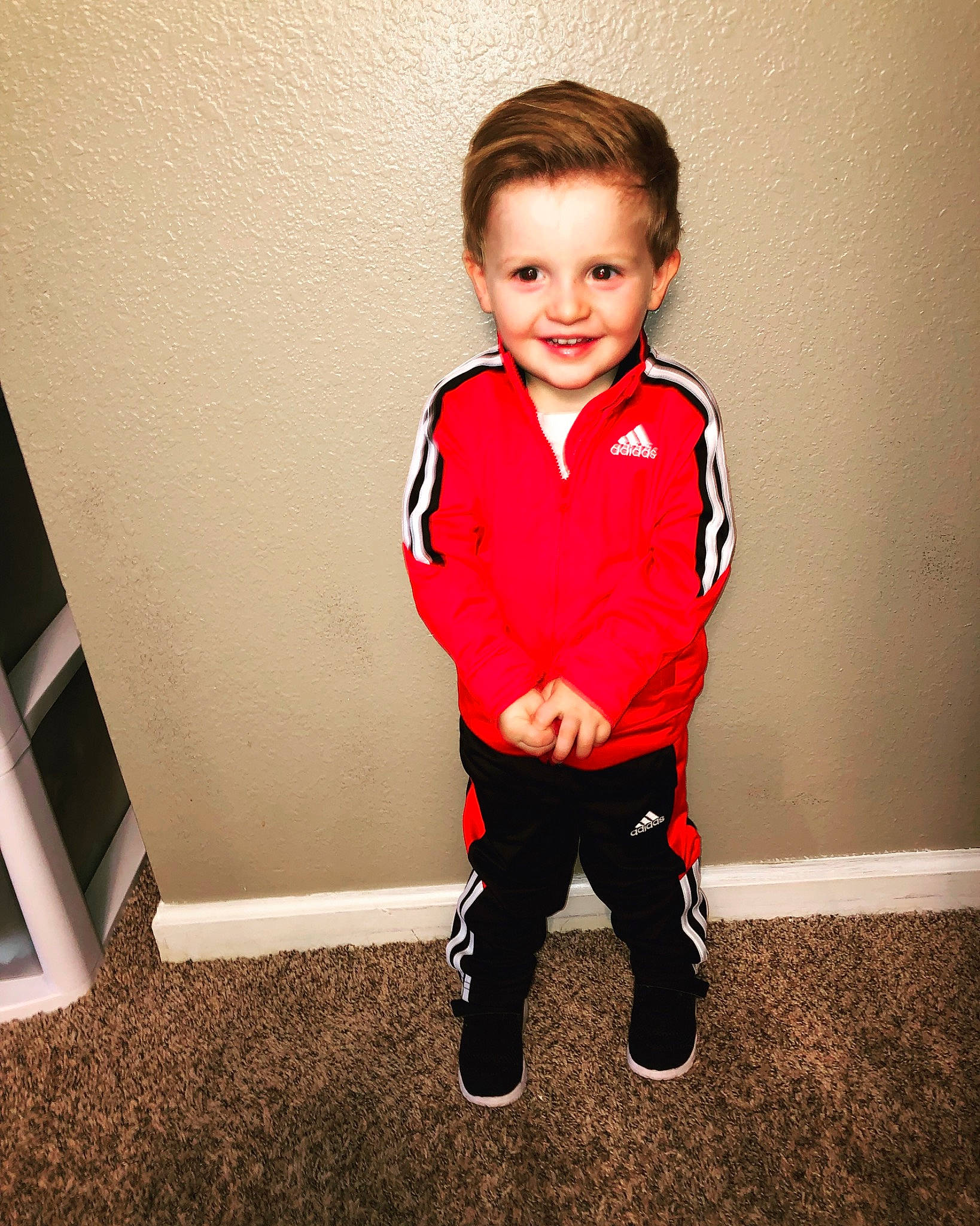 Kayden joined the competition — help win amazing prizes! child, clothing, footwear, jacket, joy, outerwear, person, red, shoe, sleeve, smile, sportswear, standing, t_shirt, toddler, trousers