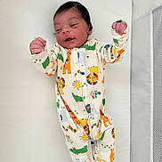 Lucas joined the competition — help win amazing prizes! baby, infant, child, onesie, animal_print, giraffe, lion, colorful, smile, lying_down, bed, mattress, crib, crib_mesh, pajamas, raised_arms, dark_hair, newborn, cute, happy