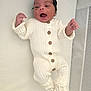 baby, newborn, infant, onesie, knit, wooden_buttons, crib, mattress, smile, laughing, happy, face, hands, feet, booties, white_background, portrait, soft_light, cozy, nursery_mesh