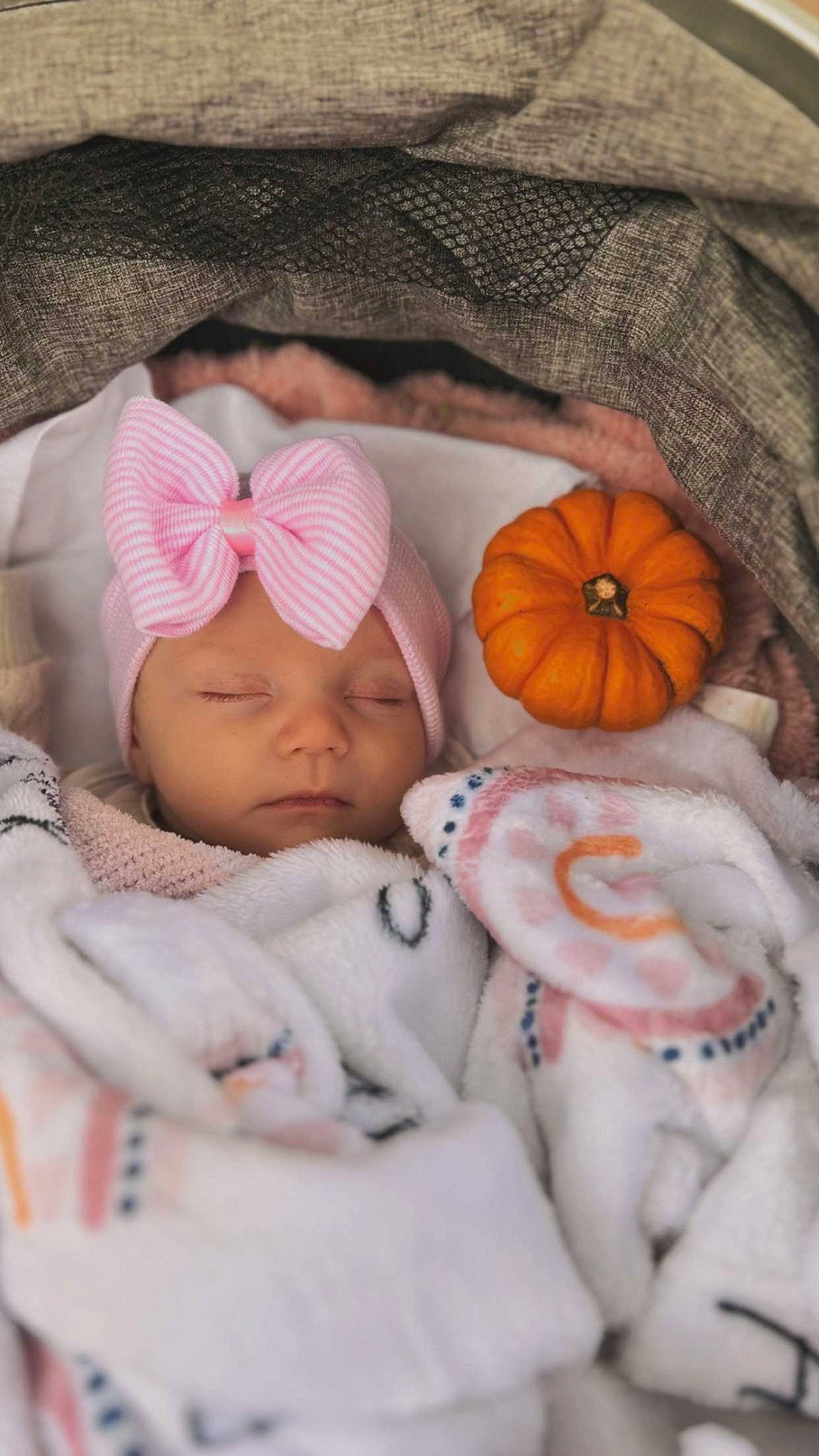 Harlynn joined the competition — help win amazing prizes! baby, baby_sleeping, baby_toddler_clothing, bedding, calabaza, cheek, child, comfort, headwear, linens, mammal, mouth, orange, person, pink, product, pumpkin, skin, textile, toddler