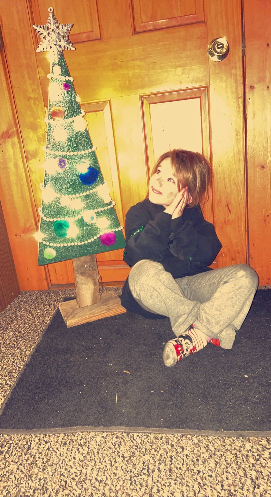 Molly Sue is registered to the contest to win money with this photo: christmas, christmas_decoration, christmas_ornament, christmas_tree, conifer, event, evergreen, flooring, fun, holiday, holiday_ornament, human_body, human_leg, joy, living_room, ornament, person, sitting, standing, tints_and_shades