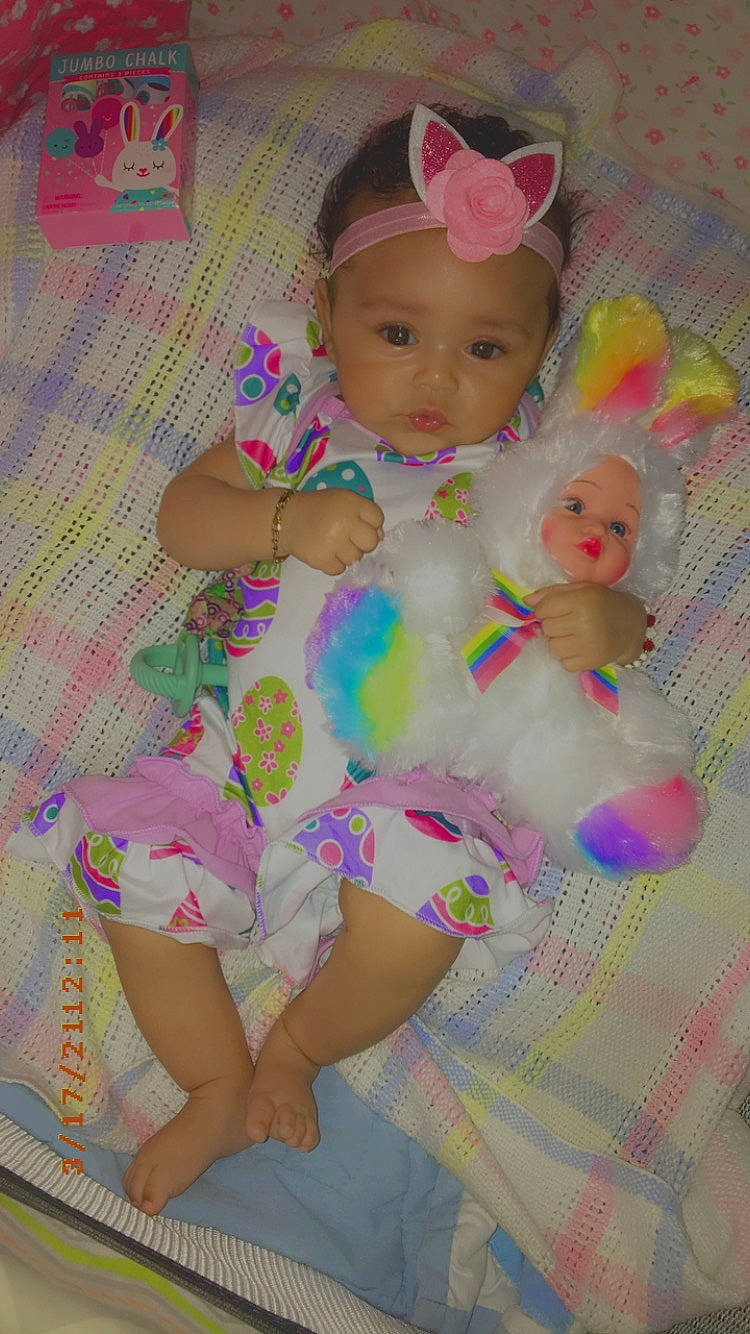 Shanelle is registered to the contest to win money with this photo: baby, baby_products, baby_toddler_clothing, cheek, chest, diaper, eye, fun, happy, head, headwear, human_leg, iris, knee, magenta, pattern, person, pink, smile, textile