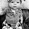 baby, child, infant, portrait, black_and_white, cow_print, bow, headband, outfit, clothing, sitting, blanket, fuzzy_blanket, indoors, close_up, wide_eyed, adorable, fashion, baby_fashion, photography