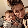 Abraham participe au concours pour gagner de l'argent avec cette photo : baby, mother, selfie, indoor, portrait, cuddling, mickey_mouse, pajamas, blanket, hair_bun, bedroom, stuffed_toy, face, eyes, hand, smile, cozy, fabric_pattern, parenting, close_up