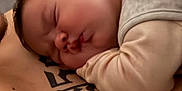 Joy a rejoint le concours — aidez-le/la à gagner de superbes lots ! baby, sleeping, tattoo, skin, indoor, person, closeup, peaceful, child, resting, infant, head, face, arm, soft, human, portrait, cozy, warm, quiet