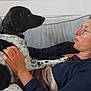Asha participe au concours pour gagner de l'argent avec cette photo : woman, dog, couch, blanket, glasses, indoor, pet, relaxing, casual, comfort, human, animal, black_and_white_dog, resting, home, friendship, affection, seated, portrait, furniture