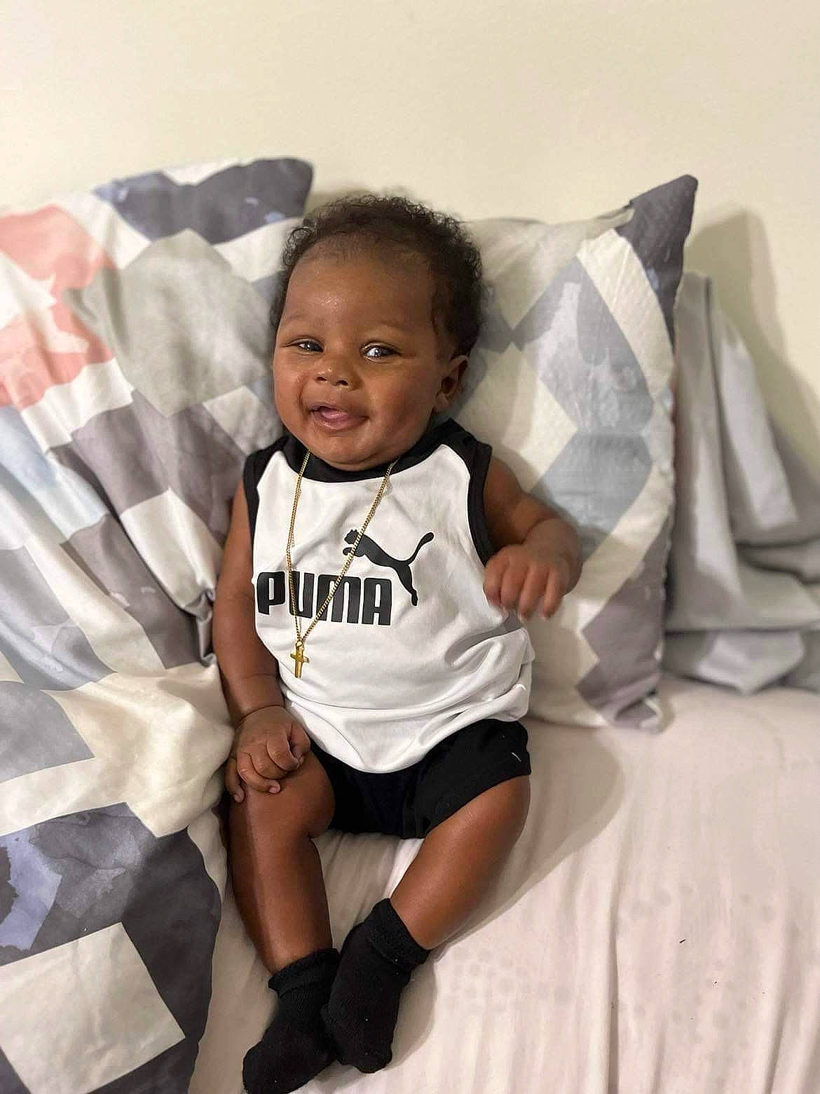 Kyson joined the competition — help win amazing prizes! baby, baby_toddler_clothing, child, comfort, couch, flash_photography, happy, human_leg, leg, linens, person, pillow, room, sleeve, smile, sportswear, t_shirt, textile, thigh, throw_pillow