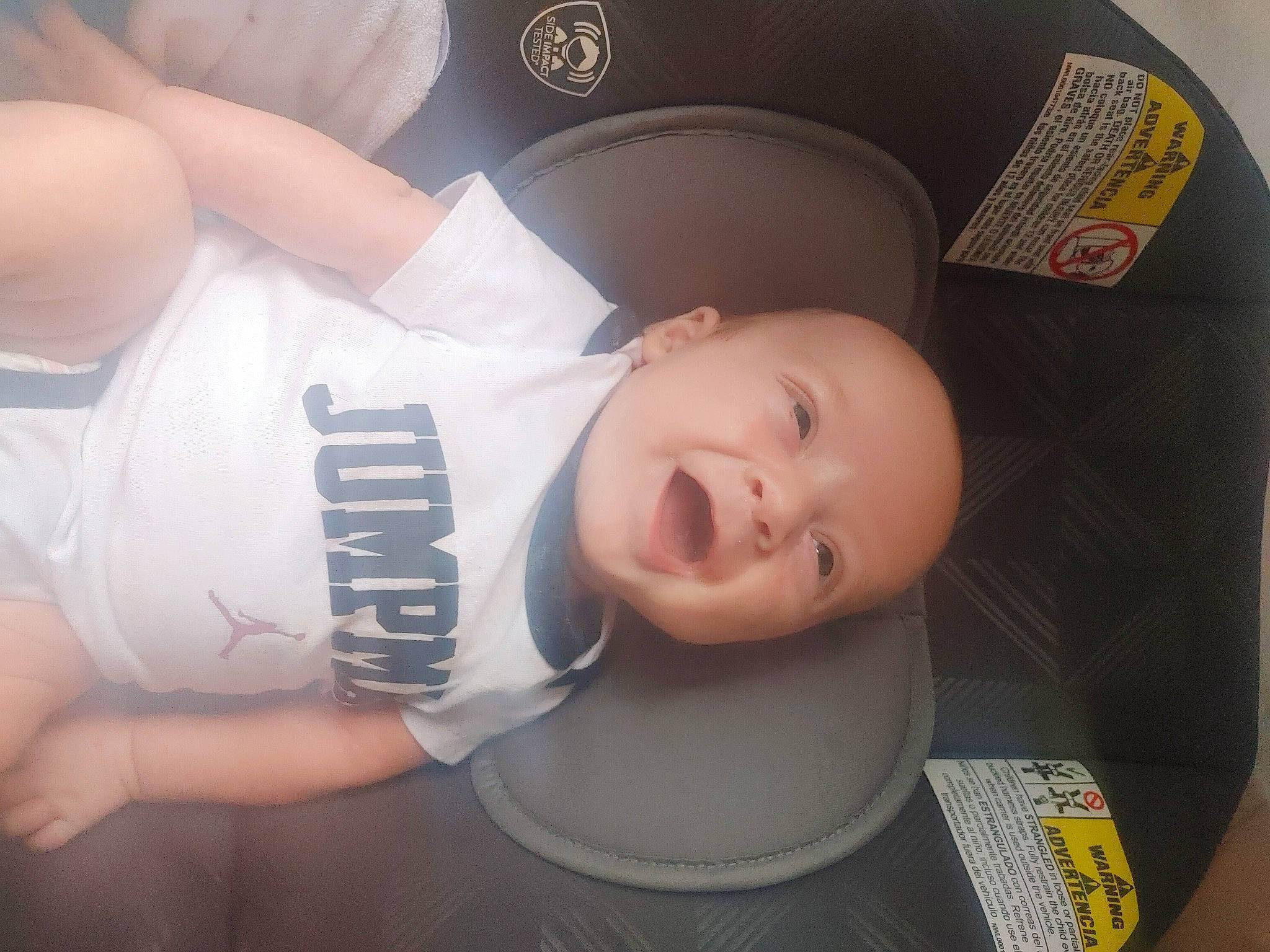 Grayson is registered to the contest to win money with this photo: abdomen, audio_equipment, baby, baby_carriage, baby_products, baby_toddler_clothing, car_seat, cheek, chest, child, comfort, cool, elbow, fun, headgear, person, personal_protective_equipment, sitting, t_shirt, thigh
