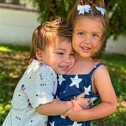 Courtney joined the competition — help win amazing prizes! child, children, hug, outdoor, smile, girl, boy, dress, hair_bow, happy, greenery, sunlight, portrait, summer, casual_clothing, friendship, playful, cute, nature, toddler