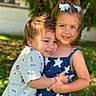 child, children, hug, outdoor, smile, happy, girl, boy, dress, hair_bow, sunlight, grass, tree, casual_clothing, summer, portrait, friendship, sibling, nature, playful