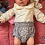 Evy Et Lylou participe au concours pour gagner de l'argent avec cette photo : baby, beige, blanket, child, clothing, cute, face, floral, indoor, infant, knitwear, lying_down, patterned_clothing, person, pink, playtime, portrait, socks, soft_toys, toy