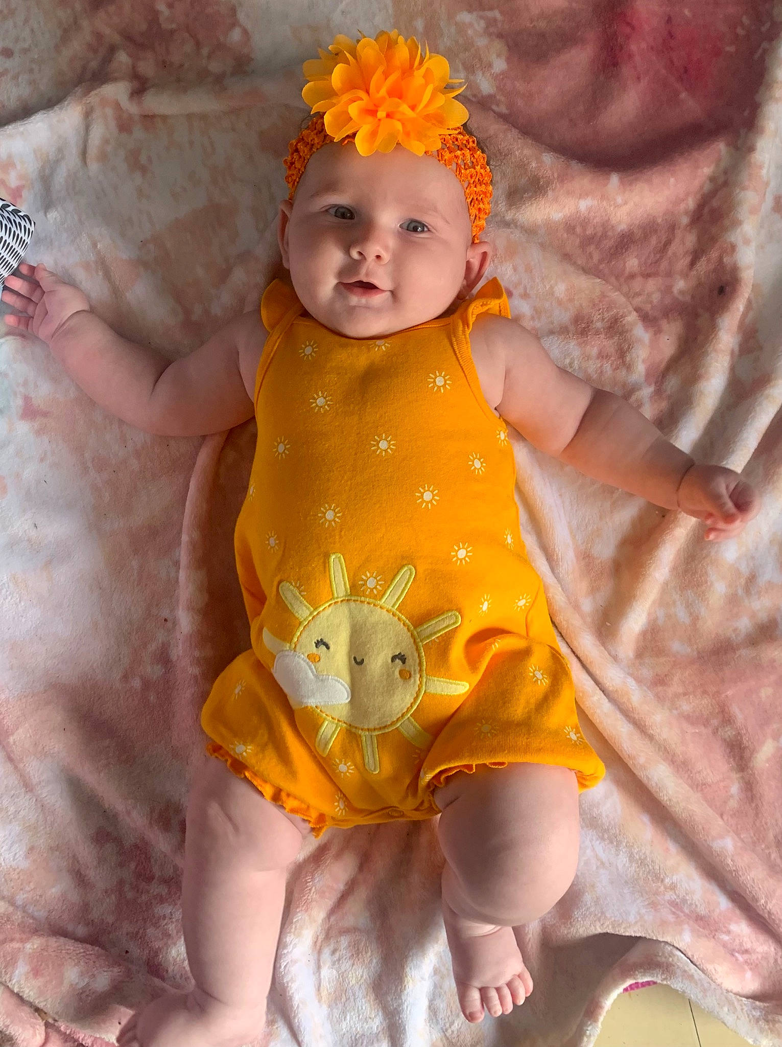 Rosalie participe au concours pour gagner de l'argent avec cette photo : abdomen, baby, baby_toddler_clothing, cheek, dress, eye, face, happy, head, headwear, human_body, iris, lip, nose, orange, person, pink, skin, stomach, toddler